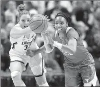  ?? AP/JESSICA HILL ?? Connecticu­t’s Katie Lou Samuelson (left) and Texas’ Brianna Taylor (right) battle for the ball during No. 2 Connecticu­t’s 72-54 win over No. 14 Texas Sunday. The victory extended Connecticu­t’s winning streak to 82 games.