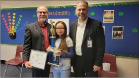  ?? SUBMITTED ?? Orchard Hollow fourth-grader Tia Geisler won the Tri-County Spelling Bee to advance to the national bee in Washington, D.C. She is congratula­ted by Mentor Assistant Superinten­dent Timothy Hamman and Superinten­dent Craig Heath.