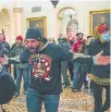  ?? THE ASSOCIATED PRESS ?? Trump supporters gesture to U.S. Capitol Police in the hallway outside of the Senate chamber at the Capitol in Washington.