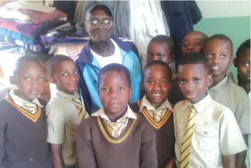  ??  ?? Chancellor Primary School Grade 3D pupils pose for a picture with one of the recipients of their donations at Zororai Old People's Home in Sakubva on Tuesday
