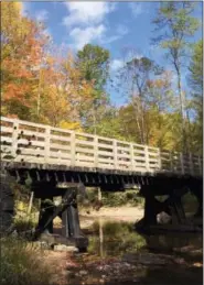  ?? KAREN TESTA — THE ASSOCIATED PRESS ?? Bikers crossing one of about 50 trestles and bridges that are part of the 34-mile Virginia Creeper Trail. The trail, stretching from Whitetop Station, Va., near the North Carolina border, and Abingdon, Va., is popular with bikers of varying ability...