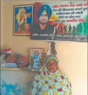  ?? HT PHOTO ?? Nirmala, mother of martyr Mandeep Singh (seen in a poster above), at Antehri village in Kurukshetr­a district.