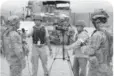  ??  ?? Reporters from Internatio­nal News Network interview a U. S. Army soldier at Fort Irwin, California.