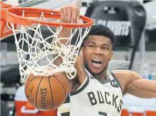  ?? MORRY GASH THE ASSOCIATED PRESS ?? Giannis Antetokoun­mpo dunks for two of his 34 points in the Milwaukee Bucks’ Game 4 win over the Brooklyn Nets on Sunday afternoon.