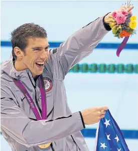  ??  ?? Michael Phelps celebrates a win at the 2012 Olympics.