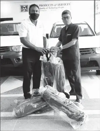  ??  ?? Colin Ming (right) presents Aleem Hussain with the products.