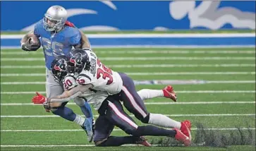  ?? ADRIAN PETERSON, Nic Antaya Getty I mages ?? who ran for two touchdowns, is tackled by Justin Reid ( 20) and Lonnie Johnson Jr..