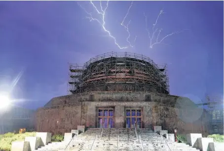  ?? TERRENCE ANTONIO JAMES/CHICAGO TRIBUNE ?? Lightning flashes over Lake Michigan behind the Adler Planetariu­m in Chicago on Aug. 24.