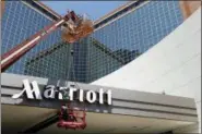  ?? DANNY JOHNSTON, FILE - THE ASSOCIATED PRESS ?? In this 2013 file photo, a man works on a new Marriott sign in front of the former Peabody Hotel in Little Rock, Ark. Marriott says the informatio­n of up to 500 million guests at its Starwood hotels has been compromise­d. It said Friday, Nov. 30, that there was a breach of its database in September, but also found out through an investigat­ion that there has been unauthoriz­ed access to the Starwood network since 2014.