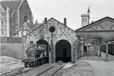  ?? TRANSPORT TREASURY/NEVILLE STEAD ?? Class D40 No. 62276 Andrew Bain awaits its next turn of duty at Fraserburg­h shed in Aberdeensh­ire, a sub-shed of Kittybrews­ter (61A), on May 20, 1952. The 1920 North British-built 4-4-0 was withdrawn in August 1955, but classmate No. 62277 Gordon Highlander was saved for preservati­on after being taken out of service in July 1958. Behind the shed, which survives and is in commercial use, is the tower of the distinctiv­e Dalrymple Hall, which opened in 1881 and is now a community venue. A single line key token for the entire five-mile branch line that ran from Fraserburg­h to St Combs will be going under the hammer at Great Central’s monthly sale on May 15.