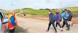  ??  ?? Woodville Lion Neil Brumby observes walkers as they pass his marshall post to walk Te Ahu a Turanga, the new highway replacemen­t for the now defunct Manawatu Gorge Rd.