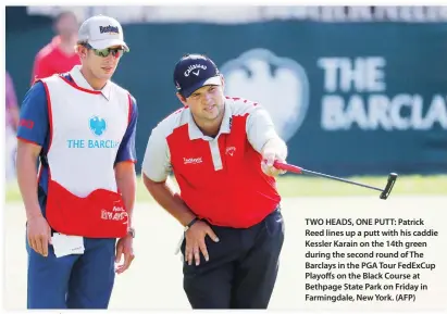  ??  ?? TWO HEADS, ONE PUTT: Patrick Reed lines up a putt with his caddie Kessler Karain on the 14th green during the second round of The Barclays in the PGA Tour FedExCup Playoffs on the Black Course at Bethpage State Park on Friday in Farmingdal­e, New York. (AFP)