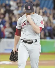  ??  ?? EXTRA PAINFUL: Craig Kimbrel walks off the mound last night after allowing the winning home run by the Blue Jays’ Curtis Granderson (top right), which gave the Red Sox a 4-3 loss. The Sox rallied to tie in the ninth, but it was cut short when Eduardo...