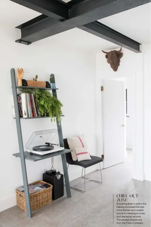  ??  ?? CHILL-OUT ZONE
Knocking down a wall in the hallway increased the size of the kitchen and created a nook for listening to music and displaying records.
The painted shelves are from the Futon Company