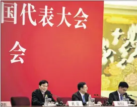  ?? NG HAN GUAN / ASSOCIATED PRESS ?? Tuo Zhen (left), spokesman for the 19th National Congress of the Communist Party of China, speaks Tuesday during a news conference at the Great Hall of the People in Beijing. The twice-a-decade meeting begins today.