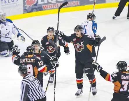  ?? CHRIS PULLEN/ FOR THE CALGARY HERALD ?? The Calgary Hitmen celebrate a first- period goal against the Kootenay Ice in Game 3 of their opening round playoff series on Tuesday night. Calgary won 8- 7 in overtime and now leads the series 2- 1.