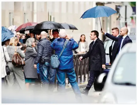  ??  ?? France’s President-elect Emmanuel Macron walks in a street, on Thursday in Paris. (AFP)