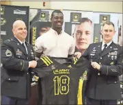  ?? Photo contribute­d by Todd Ollis ?? Rome High’s Adam Anderson (center) is presented his jersey for the U.S. Army All-American Bowl by representa­tives from the U.S. Army during a special assembly at the school Wednesday. Anderson is ranked as the No. 2 overall outside linebacker in the...