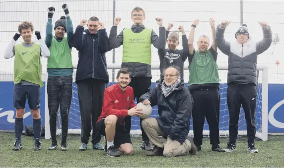  ??  ?? Footballer­s at the Every Player Counts programme at the Beacon of Light. Coach Jamie Wilson is front left beside Stuart Goshawk, CEO of Wembley National Stadium Trust.