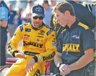  ?? THE ASSOCIATED PRESS ?? Matt Kenseth, left, talks to a member of his crew prior to Friday’s qualifying for Sunday’s Cup Series race at Richmond Internatio­nal Raceway.