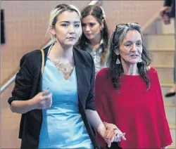  ?? CP PHOTO ?? Delilah Saunders, left, walks with her mother Miriam Saunders, while attending the Missing and Murdered Indigenous Women and Girls inquiry in Membertou in October.