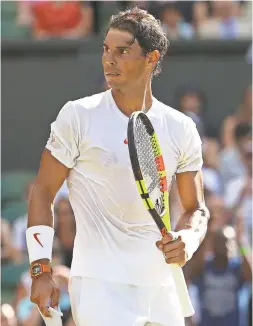  ?? MATTHEW STOCKMAN/GETTY IMAGES ?? Rafael Nadal looks on during his men’s singles first-round match against Dudi Sela of Israel on day two of Wimbledon at the All England Lawn Tennis and Croquet Club.