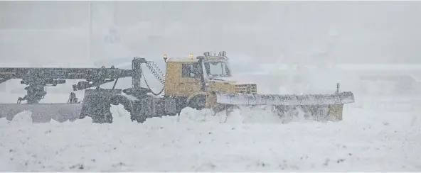  ?? ?? TRAVEL: Snow ploughs attempt to clear the runway at Aberdeen Airport, which was shut due to heavy snow brought by Storm Eunice.