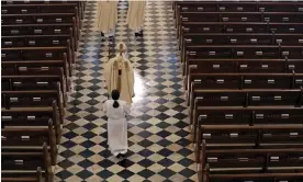  ?? Photograph: Gerald Herbert/AP ?? Archbishop Gregory Aymond conducts the procession to lead a livestream­ed Easter mass in St Louis Cathedral in New Orleans in April 2020.