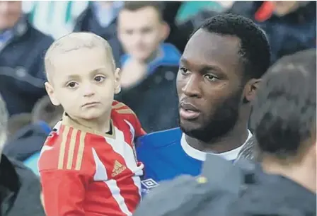  ??  ?? Everton striker Romelu Lukaku carries Bradley onto the Goodison Park pitch.