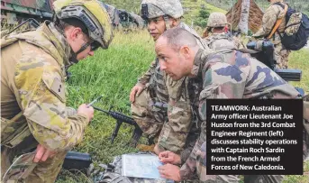  ?? TEAMWORK: Australian Army officer Lieutenant Joe Huston from the 3rd Combat Engineer Regiment ( left) discusses stability operations with Captain Roch Sardin from the French Armed Forces of New Caledonia. ??