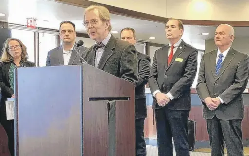  ?? MARNI PYKE/DAILY HERALD ?? DuPage Rail Safety Council Chair Lanny Wilson is flanked by local mayors and lawmakers as he outlines concerns about a merger of Canadian Pacific Railway and Kansas City Southern Railway.