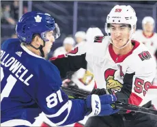  ??  ?? Toronto Maple Leafs’ Mac Hollowell, left, checks Ottawa Senators’ Alex Formenton during first period NHL Rookie Showdown hockey action in Laval, Que., Sept. 8 CP PHOTO