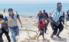  ??  ?? Back in Libya… migrants survive sinking of inflatable dinghy