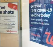  ?? MICHAEL M. SANTIAGO/GETTY ?? Flu and coronaviru­s (COVID-19) vaccine signage is seen at a Duane Reade last year in New York City.