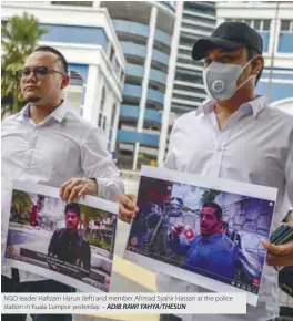  ??  ?? NGO leader Hafizam Harun (left) and member Ahmad Syahir Hassan at the police station in Kuala Lumpur yesterday. – ADIB RAWI YAHYA/THESUN