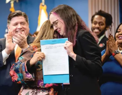  ?? PAT NABONG/SUN-TIMES ?? State Rep. Kelly Cassidy and state Sen. Celina Villanueva hold the signed House Bill 4664, which will further protect reproducti­ve health care providers and patients who are seeking care in Illinois.