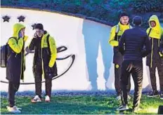  ?? AP ?? Dortmund players outside the team bus after it was damaged in an explosion before the Champions League quarter-final.