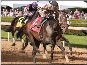  ?? (The Sentinel-Record/Richard Rasmussen) ?? Jockey Ricardo Santana Jr. and Silver State cross the wire to win the Oaklawn Handicap on Saturday at Oaklawn Racing Casino Resort in Hot Springs. It was Silver State’s fifth consecutiv­e victory.