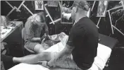  ??  ?? Tattoo artist Samantha Stine works on a tattoo for customer Blake Graff of La Plata at Hypnotique Ink in Waldorf.