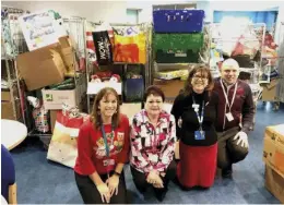 ??  ?? Kirsten Rogers Voluntary Services Manager, Karen Kendall Voluntary Services Assistant, Sharon Herring Director of Nursing Networked Care, and Andrew Kilby Patient Experience Facilitato­r with some of the gifts received for its Christmas appeal