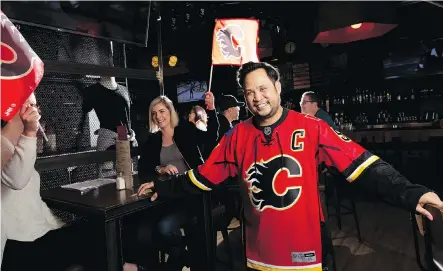  ?? LEAH HENNEL ?? Ernie Tsu, owner of Trolley 5 restaurant and bar, is ready for some Flames fever to hit Calgary’s Red Mile on Thursday.