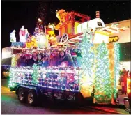  ?? Photo by Randy Moll ?? Employees of Arvest Bank rode on the bank’s float in the annual Gentry Chamber of Commerce Christmas Parade on Saturday.