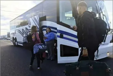  ?? BILL UHRICH - MEDIANEWS GROUP ?? Passengers prepare to board a Klein Transporta­tion bus to New York City from the Fairground­s Square Mall in Muhlenberg Township Friday, Oct. 11.