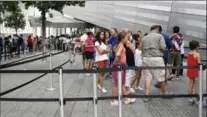  ?? KATHY WILLENS, THE ASSOCIATED PRESS ?? Visitors to the National September 11 Memorial and Museum line up in New York. It has had more internatio­nal visitors this year.