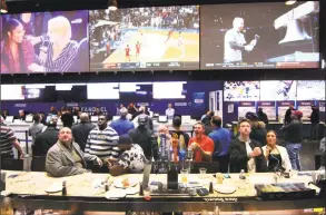  ?? Christian Abraham / Hearst Connecticu­t Media ?? Customers react as they watch the Texas Tech-Gonzaga NCAA Tournament basketball game at Fan Duel Sportsbook at the Meadowland­s in East Rutherford, N.J., on March 30. Michael Brandon, of Stamford, came to the business to try betting on the NCAA game in person. Connecticu­t is considerin­g legalizing sports betting, leaning toward a New Jersey model where people can bet in person at casinos and racetracks, as well as online.