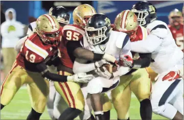  ?? Jeremy Stewart / RN-T ?? Rome High’s Adam Anderson (19), Ja’Quon Griffin (95) and K.J. Hicks surround Southwest DeKalb running back Francisco Hunter during the second quarter of Friday’s Class 5A state playoff game at Barron Stadium.