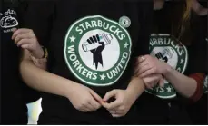  ?? JOSHUA BESSEX — THE ASSOCIATED PRESS FILE ?? Starbucks employees and supporters link arms during a union election watch party Dec. 9, 2021, in Buffalo, N.Y. The U.S. Supreme Court heard oral arguments in a case filed by Starbucks against the National Labor Relations Board.