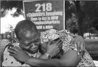  ??  ?? Obby Ezekwesili (left), coordinato­r of Bring Back our Girls, cries while trying to console Esther Yakubu, mother of a girl who appeared in a video released by Boko Haram on Sunday.