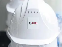  ?? BLOOMBERG ?? The logo of UBS Group is seen on a helmet during a topping-out ceremony for the group’s new office building in Hong Kong on March 27.