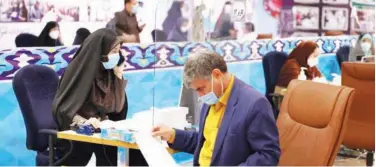  ?? Agence France-presse ?? An Iranian man registers his candidacy for presidenti­al elections in Tehran on Tuesday.